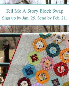 A quilt called the Tell Me A Story Quilt using fussy cut fabrics to tell stories, used to announce a new block swap. Quilt is hung on a fence with an alpaca in the background.